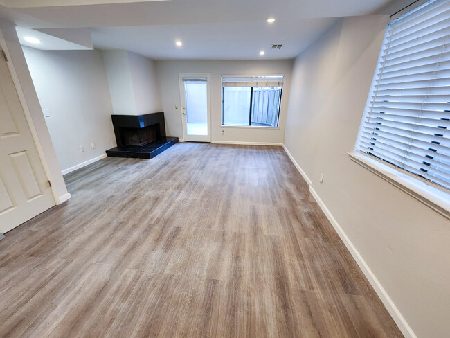 Downstairs spacious living area with wood burning fireplace - 2040 Main St