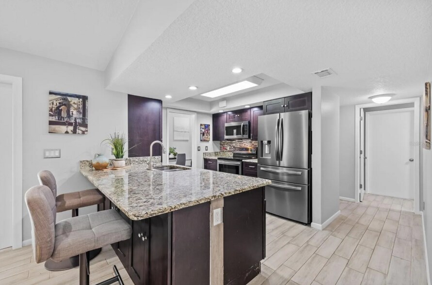 Large kitchen island with bar seating — ideal for casual meals or hosting guests. - 1932 Brainerd Ct