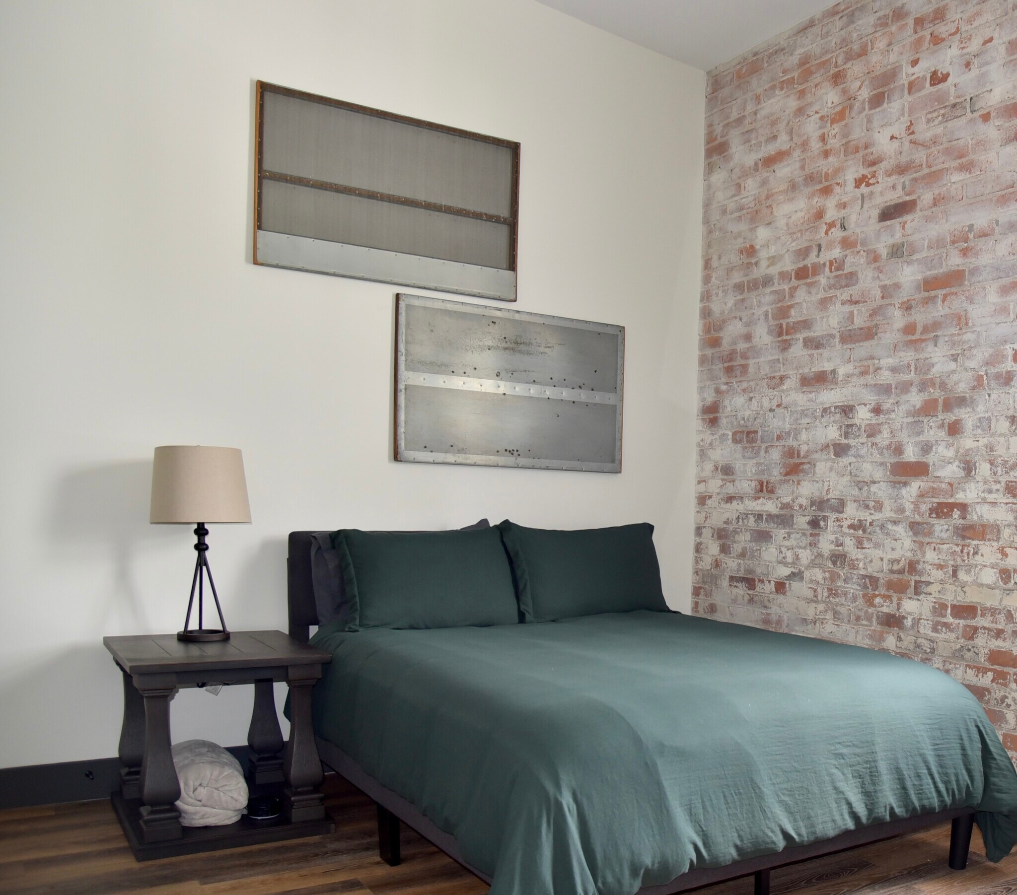 Second bedroom furnished with a queen size bed, dresser, large closet space and a smart TV - 101 W Broadway St