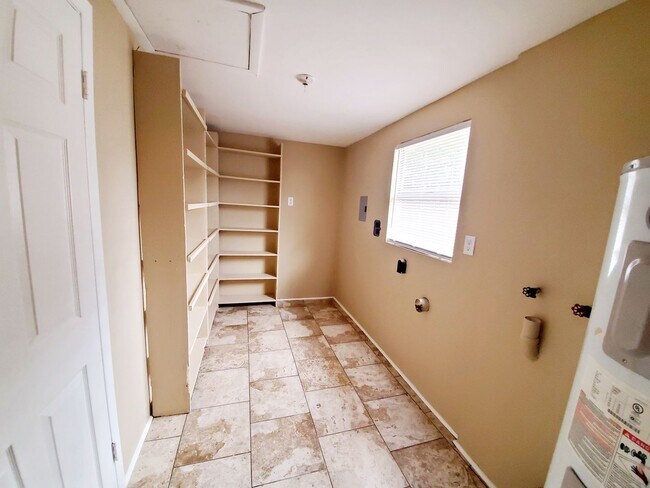 Building Photo - Three bedroom one and a half bathroom house with large yard space