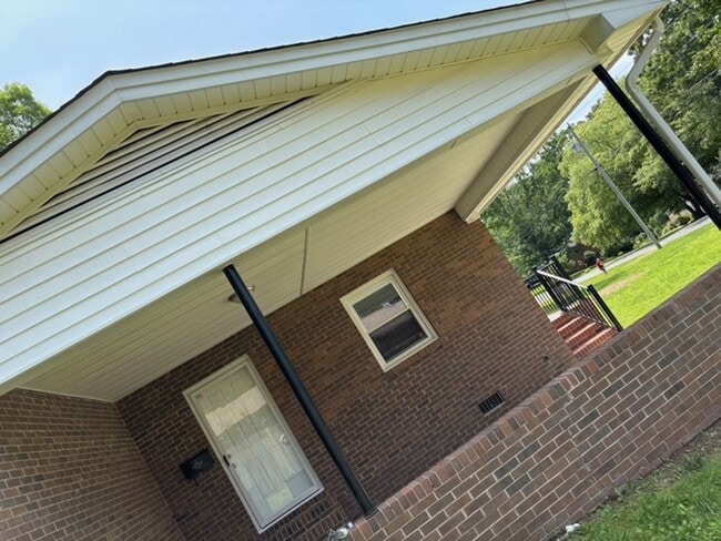Building Photo - Nice brick home, single carport, storage b...