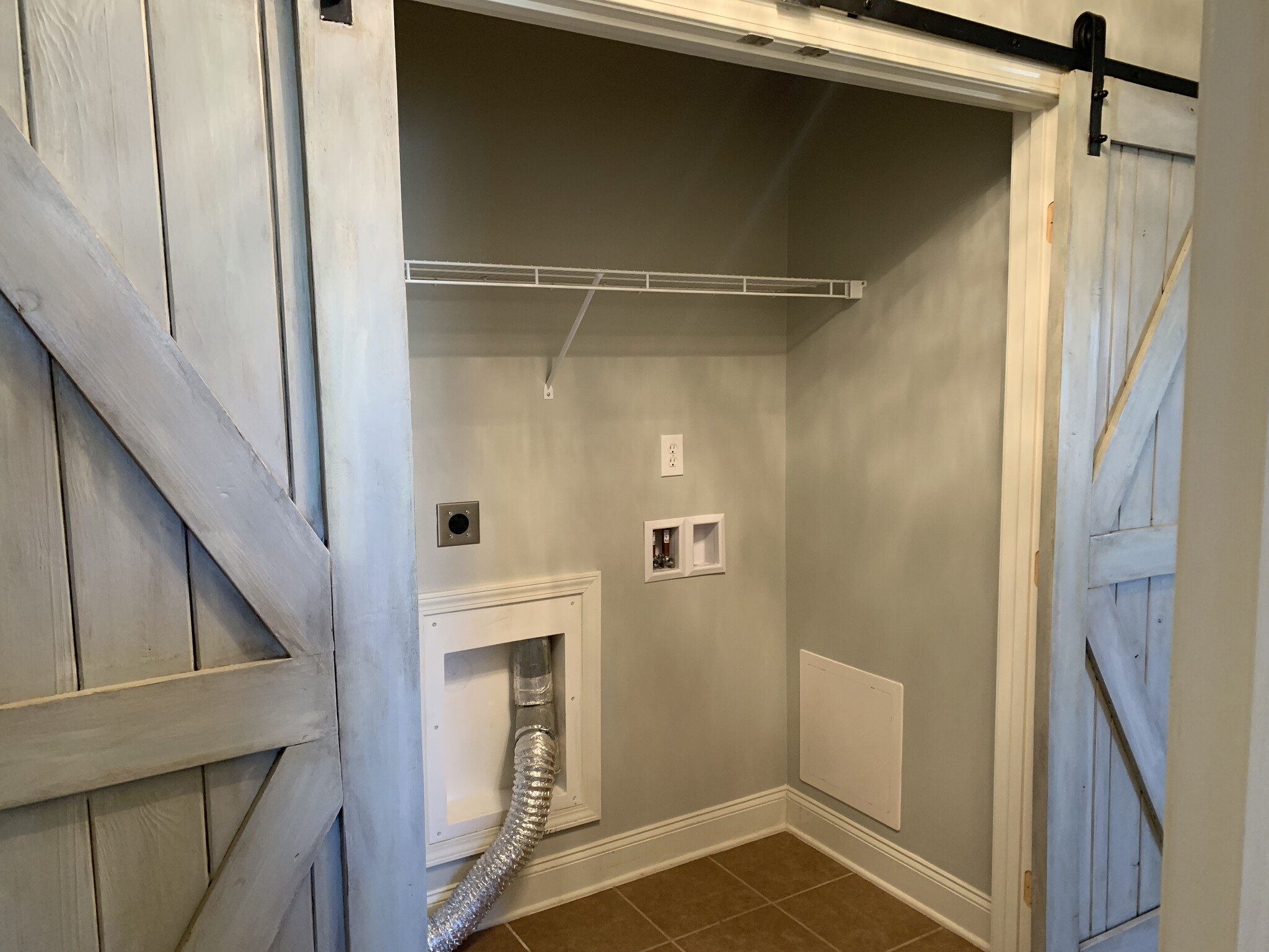 Laundry room with custom gorgeous sliding barn doors - 253 Village Springs Dr
