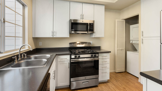 Kitchen with Stainless Steel Appliances - Schooner Bay Apartment Homes