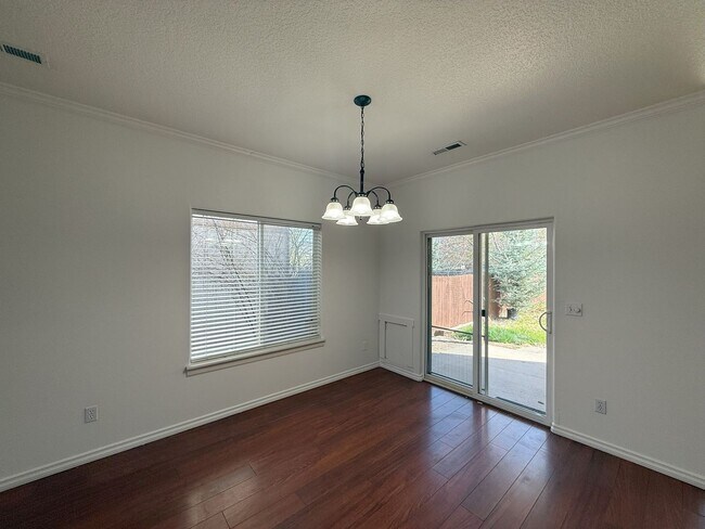 Building Photo - SPACIOUS LAYOUT! HARD SURFACE FLOORING, FENCED YARD & LARGE PATIO!
