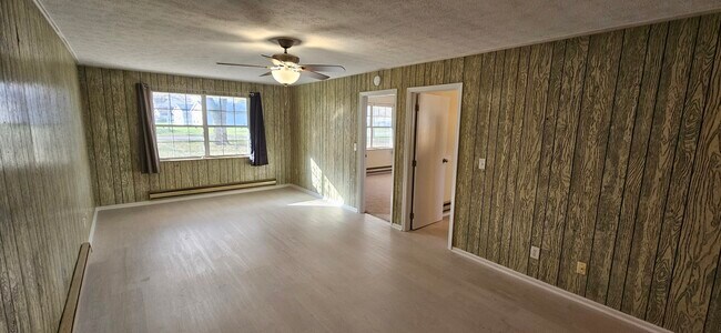 Family room with views of front living room (left door) and kitchen (right door). - 578 Tyler St