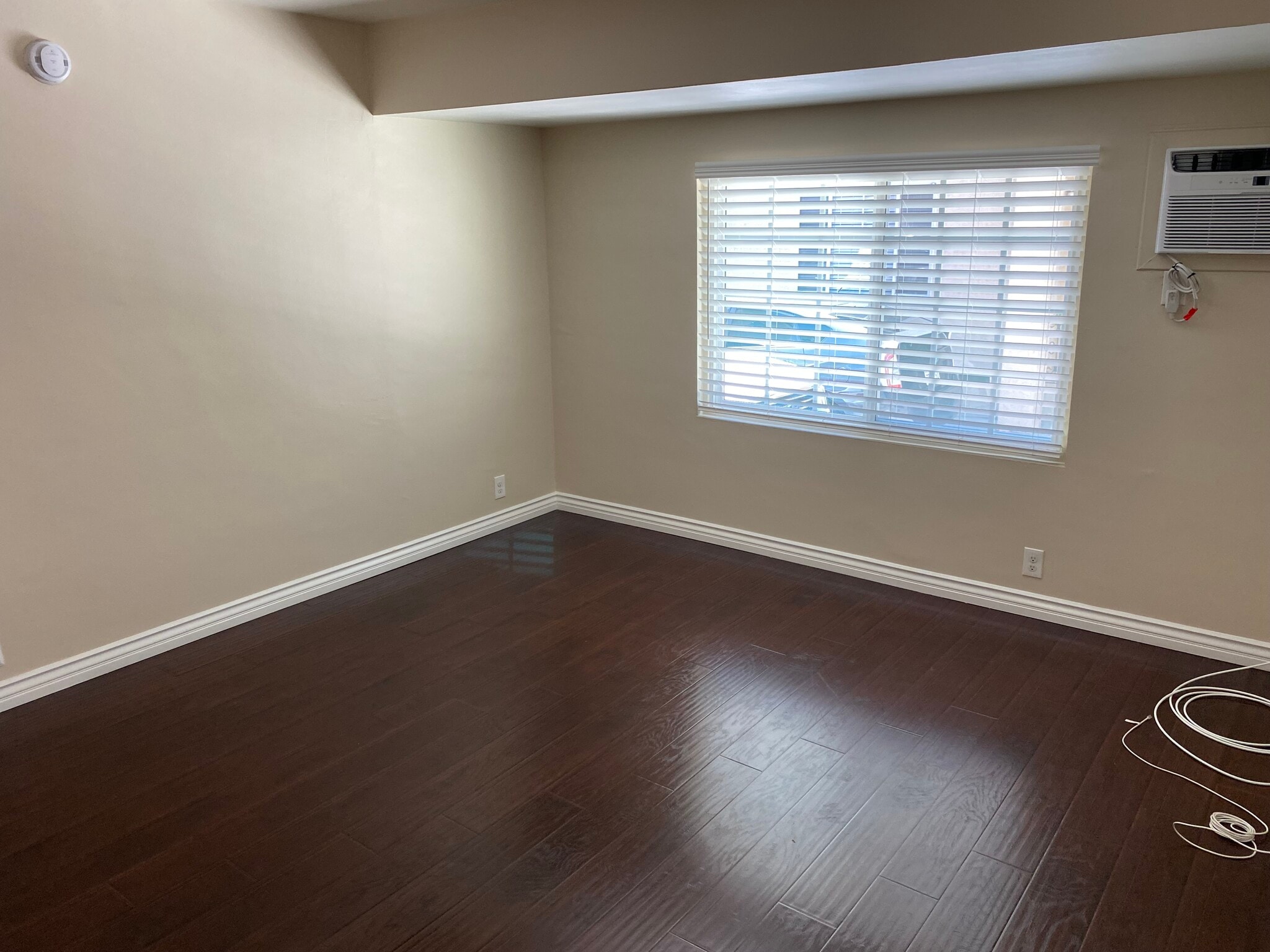 Living room with a wall ac unit - 11280 Morrison St