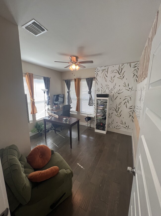 Guest room #2, home office featuring two large white boards, printer setups, 2 desks, and TV. - 422 S Olive St