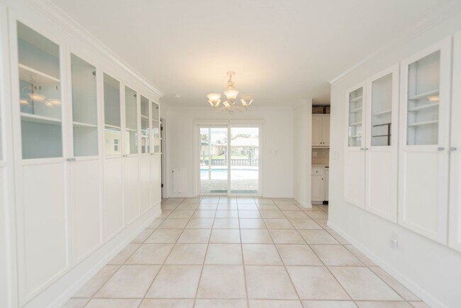 Building Photo - Live the ultimate Space Coast waterfront lifestyle at this stunning beachside canal home in Satel...