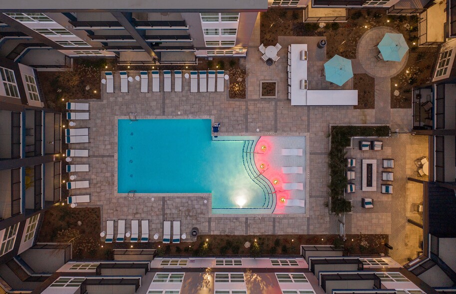 NoDa Flats Aerial View of Courtyard Pool Area with Lounge Seating and Cabanas - NoDa Flats