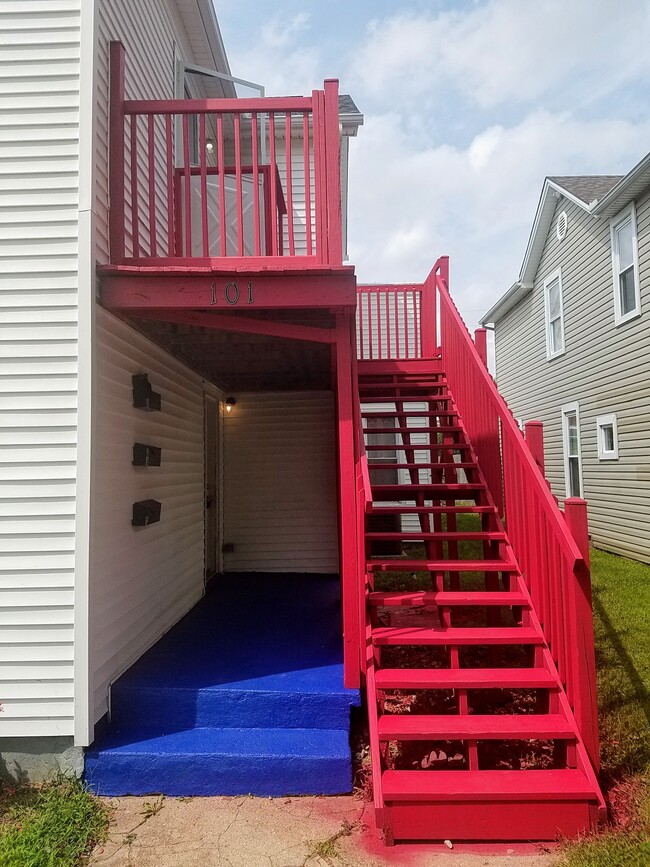 Red stairs lead up to Unit C - 101 Fairground Ave