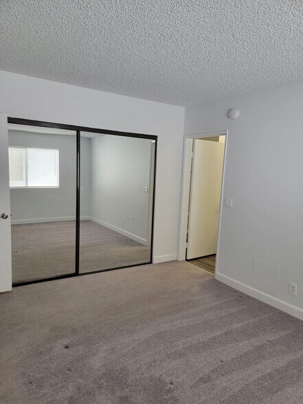 Closet in primary bedroom and doorway to master bathroom - 3751 S Canfield Ave