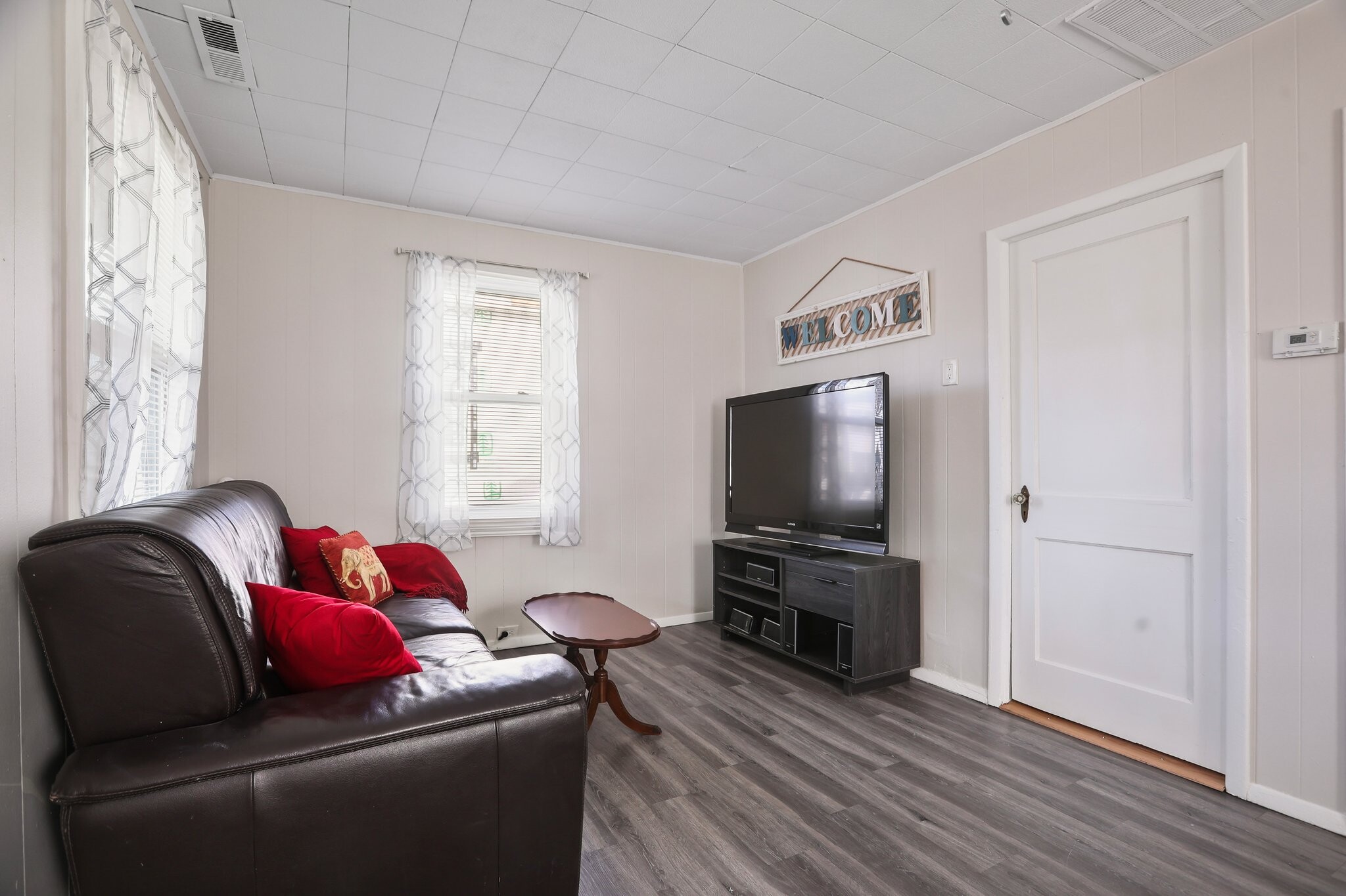 Family room space with leather couch, coffee table, and televsion - 1710 B St