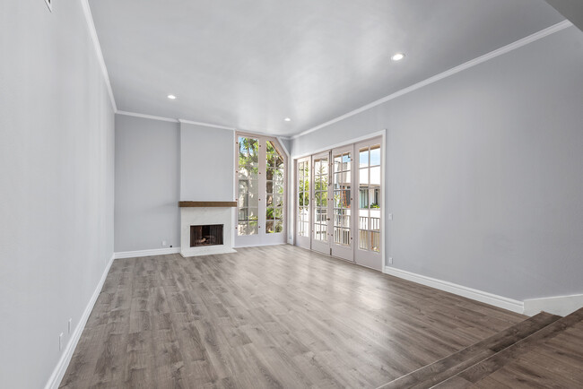 Living room with floor-to-ceiling windows and French doors - 1260 S Beverly Glen Blvd