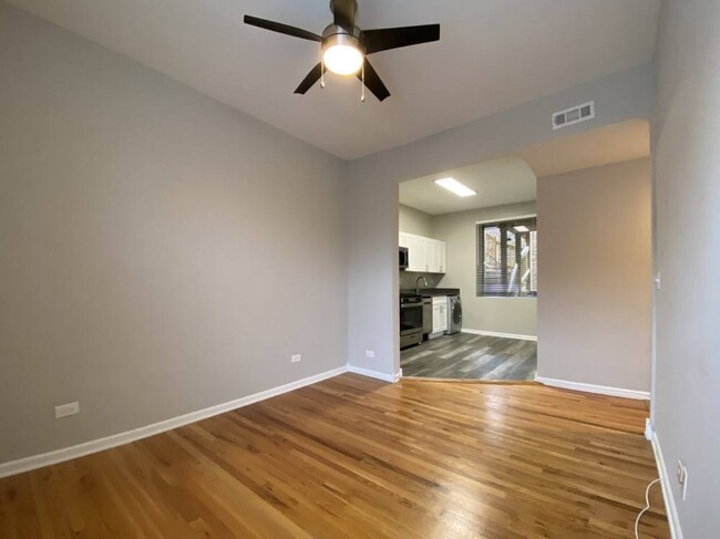 Living room with hardwood flooring and a ceiling fan - 2801 W Logan