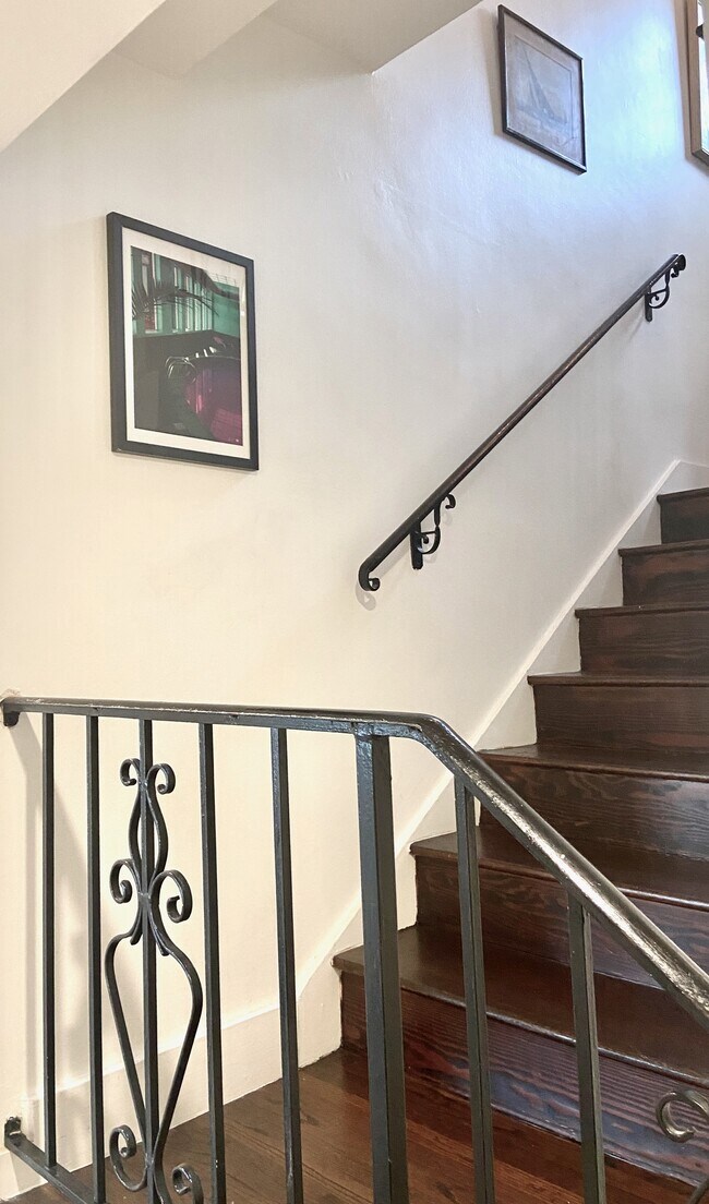Stairwell leading to the lower level with bedrooms, the main bathroom, laundry, and deck access. - 1672 Rotary Dr