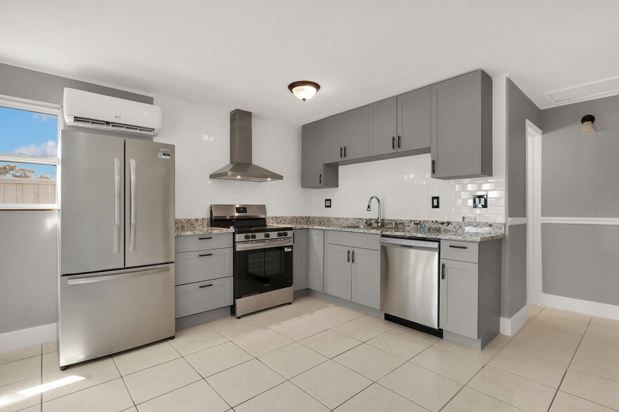 Newly renovated modern kitchen with stainless steel appliances and modern cabinets - 249 SW 12th St