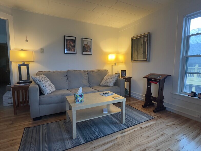 Looking towards the corner of the living/dinning room from the street side. - 25 Monroe St