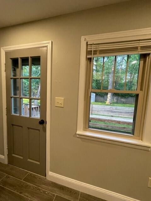 Back door, leading to deck and fenced yard with storage shed. - 214 E Vermilya Ave