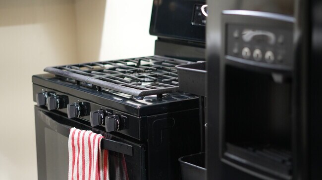 The stove has an oven and comes with basic cooking supplies. - 4160 Barrett Rd