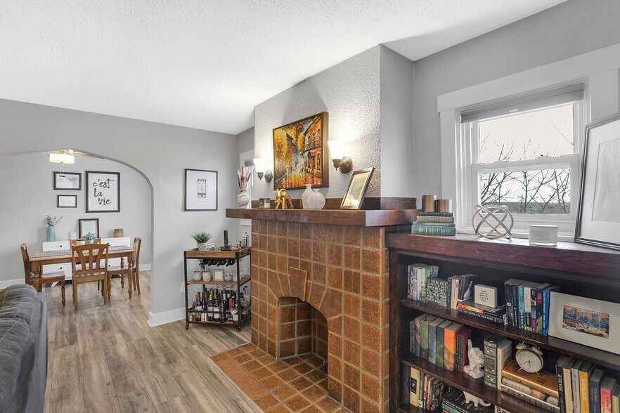 Decorative tile fireplace and built-in shelving create a beautiful focal point for the living room. - 203 Richbarn
