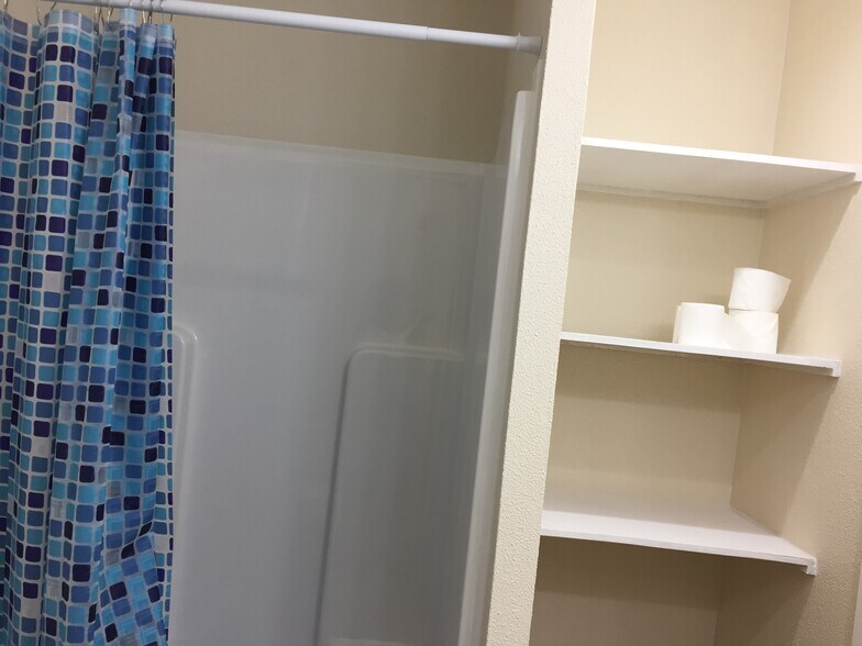 Master bathroom- shelving and shower (no tub) - 310 East 3rd St.