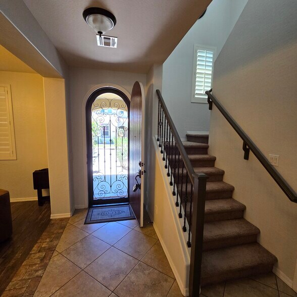 Entry with beautiful arched door and security screen door - 280 E Indigo Dr