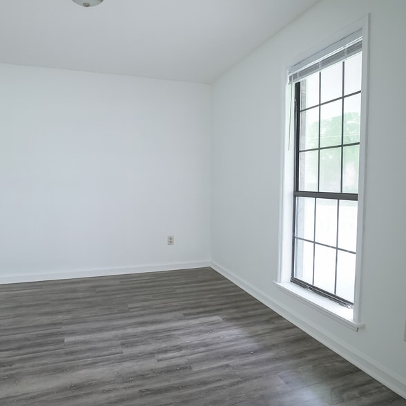 Spacious dining area with natural light and updated laminate flooring. - 2313 Salem West Dr