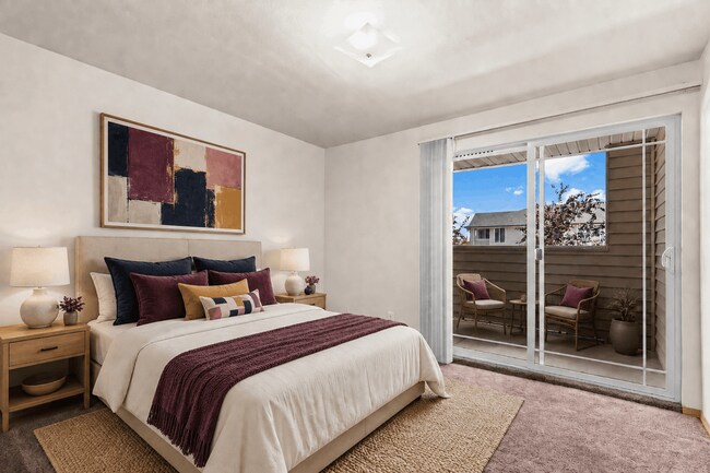 Staged bedroom with a private outdoor retreat. - Villas at Lawrence