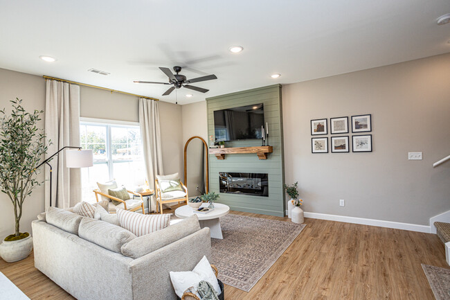 living room featuring open concept layout, decorative mantle and electric fireplace - 110 Sierra Cir