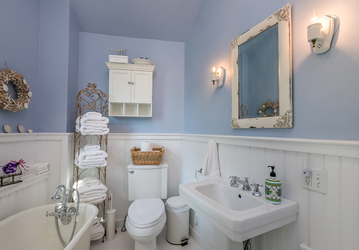 The beautiful upstairs bath with the original clawfoot tub and a glass shower. - 23 Graffam Rd