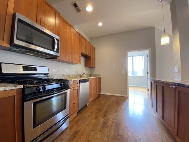 Hardwood floors, wooden cabinets, and stainless steel appliances - 1800 Milwaukee