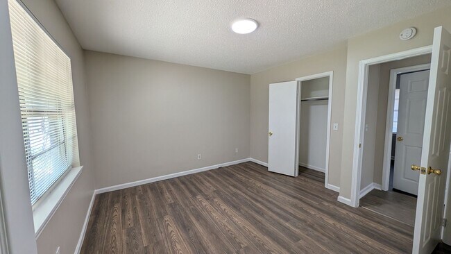 Building Photo - Fenced Yard, Lots of Light, Hard Floors Throughout
