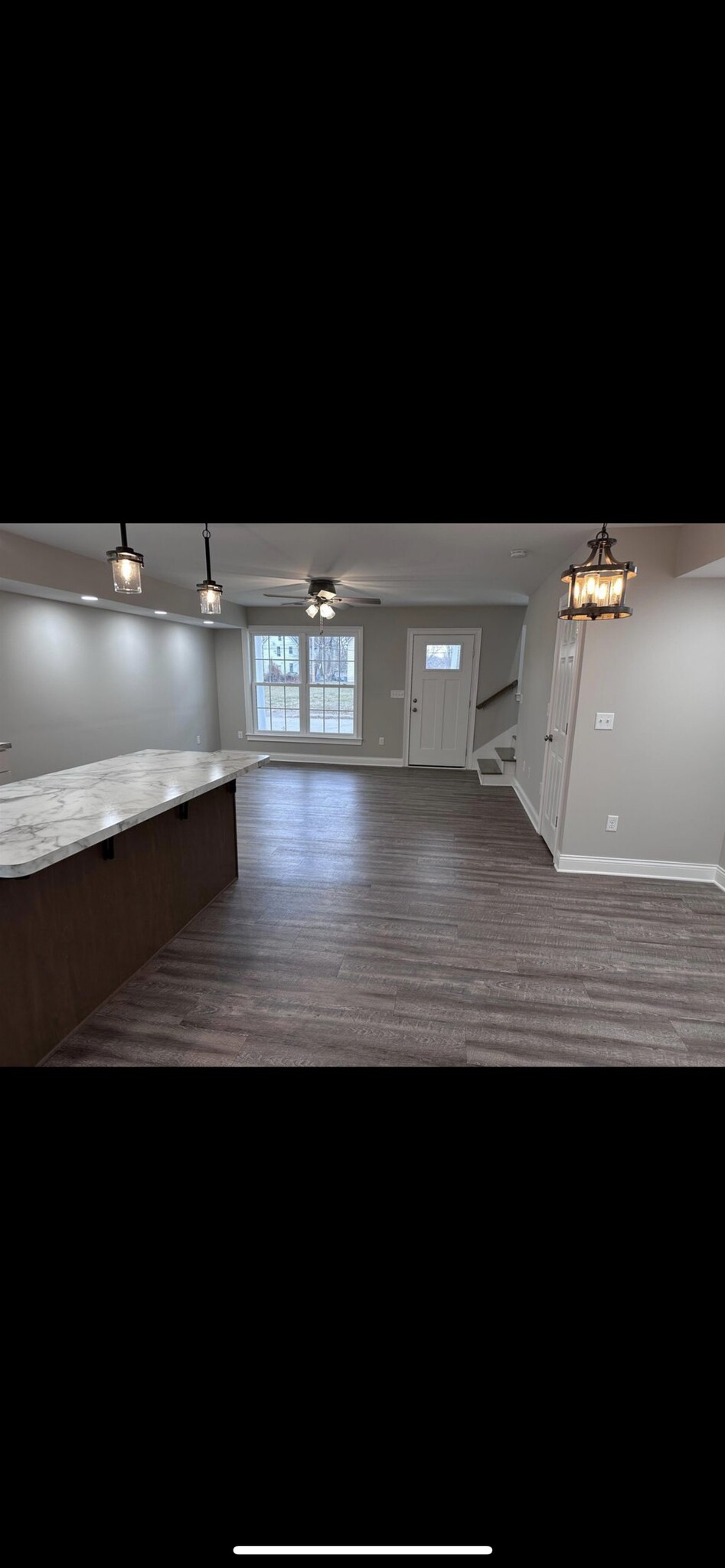 Open floor downstairs with living room and dining area - 713 E Powell Ave