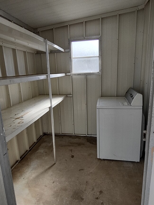 STORAGE SHED WITH DRYER (WASHER IS INSIDE) - 7402 Demure Ln