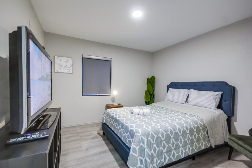 Unwind with your fave shows on your comfy queen bed in Bedroom 3 - 5551 Churchward St