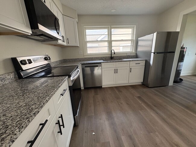 Building Photo - Fully Renovated 3BR/1.5BA – Prime Location + Lawn Care Included