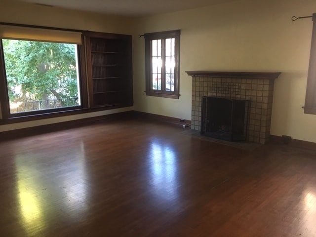 Large picture window in living room and with built-in bookcases on either side. - 862 Allen Ave