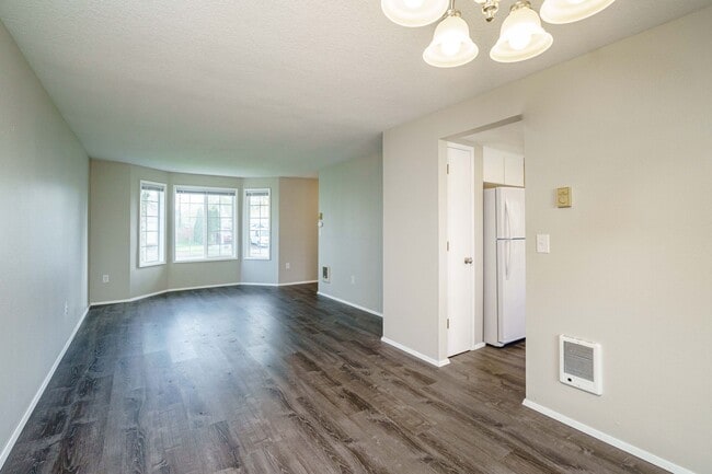 Building Photo - Recently Updated with Wood Laminate Flooring and Fresh Paint