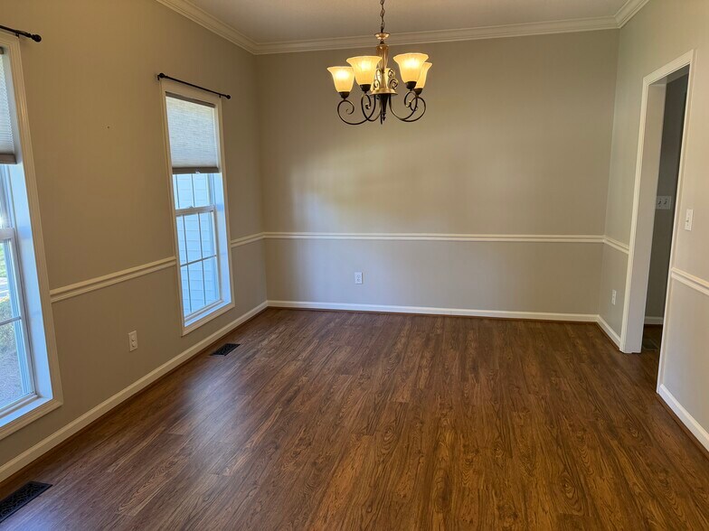 The Dining Room is also located on the front of the home with chair rail and crown moldings - 6419 Woodmont Rd
