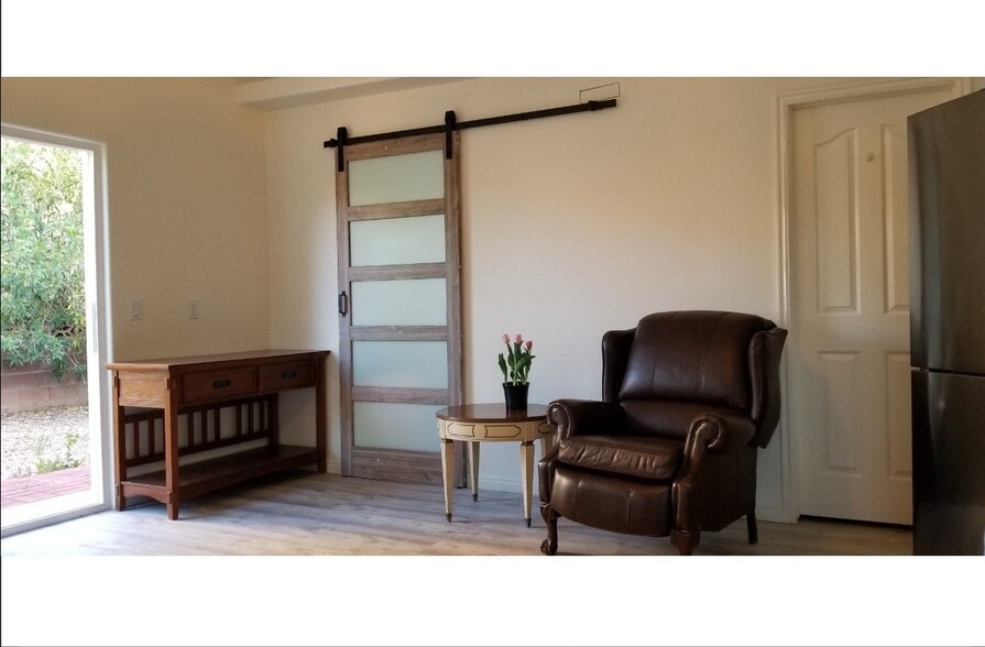 2. Studio entrance & E & N-facing living room (garden views + patio door with privacy blinds) - 137 E 755 S