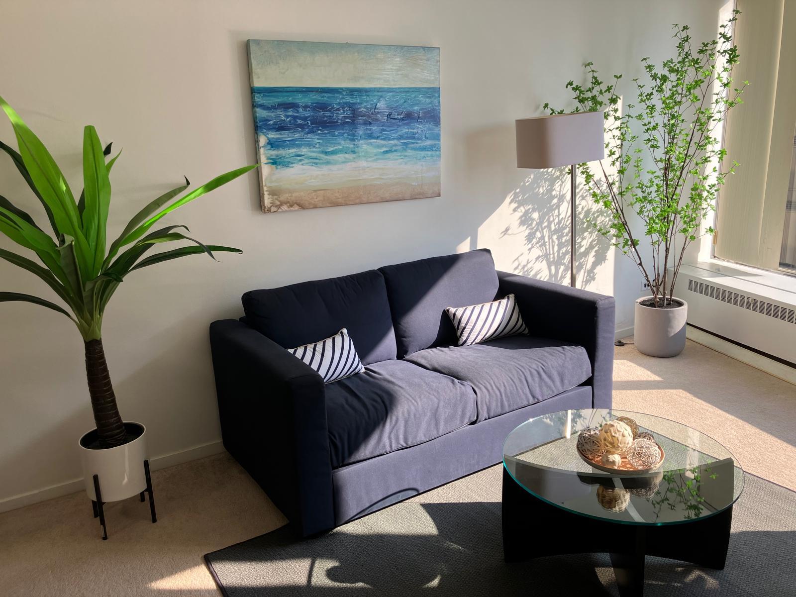 Comfy living room with sofa, TV and an amazing river view - 8200 E Jefferson Ave