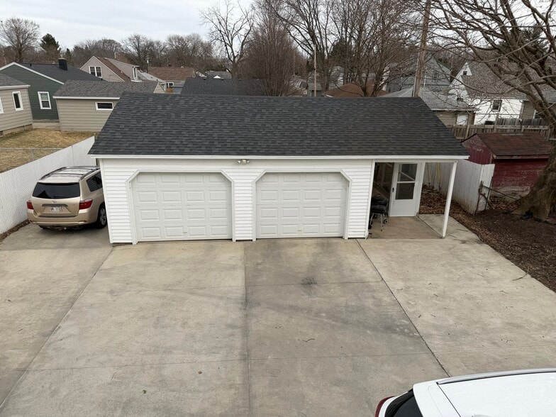 1 garage spot, and the car parked to the left, would be yours as well - 2113 N Sherman Ave