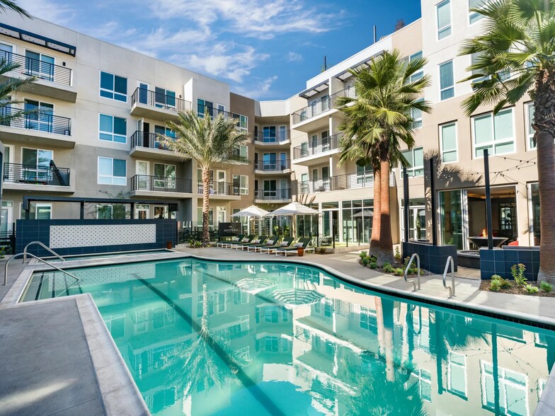 Modera Pomona features a tranquil, resort-style pool with a relaxing lounge area. - Modera Pomona