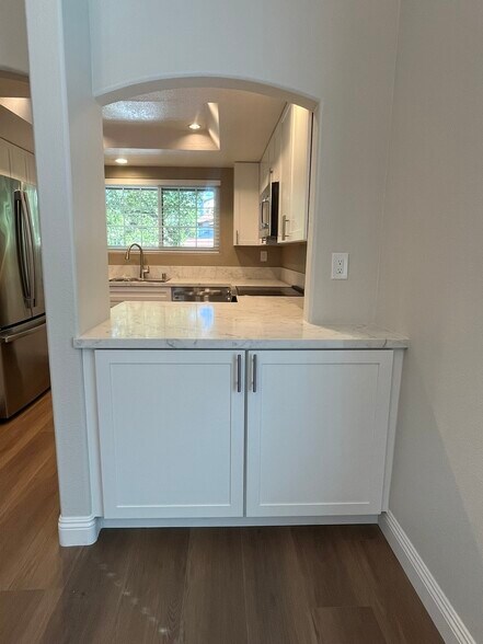 beautiful quartz couter top over custom built-in starage cabinet in dining area - 16274 Avenida Venusto