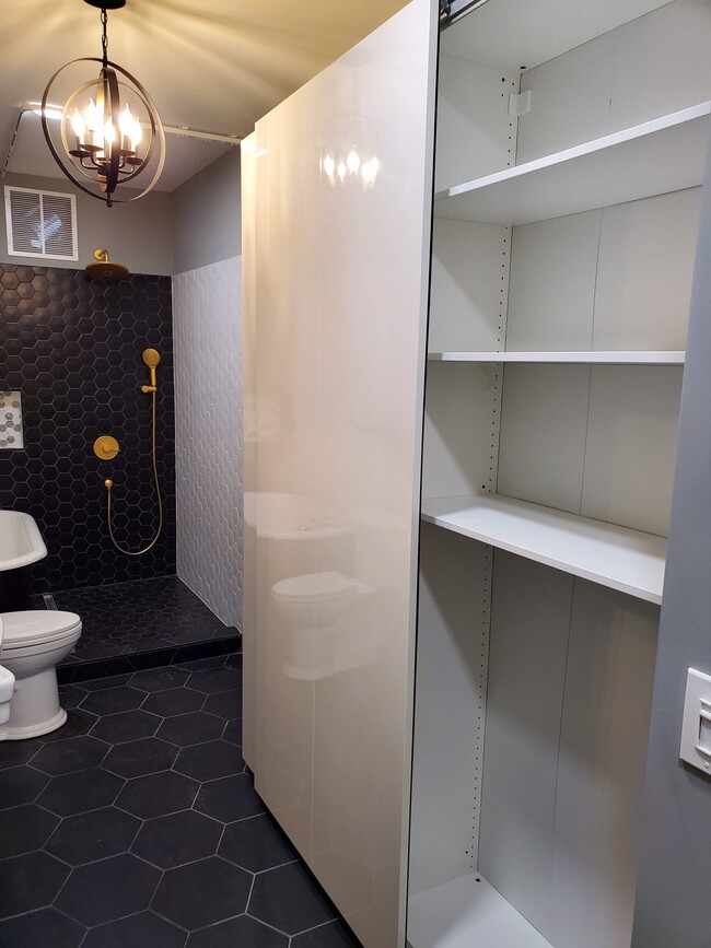 Linen closet with shelving in bathroom - 579 W. 13th St