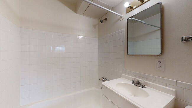 Experience simplicity and style in this elegantly designed bathroom space. - Melody Apartments