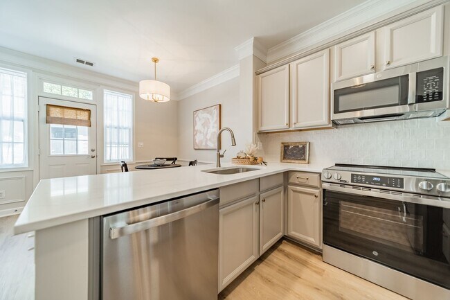 Building Photo - UPGRADES! Two Bedroom Townhouse - Six Mont...