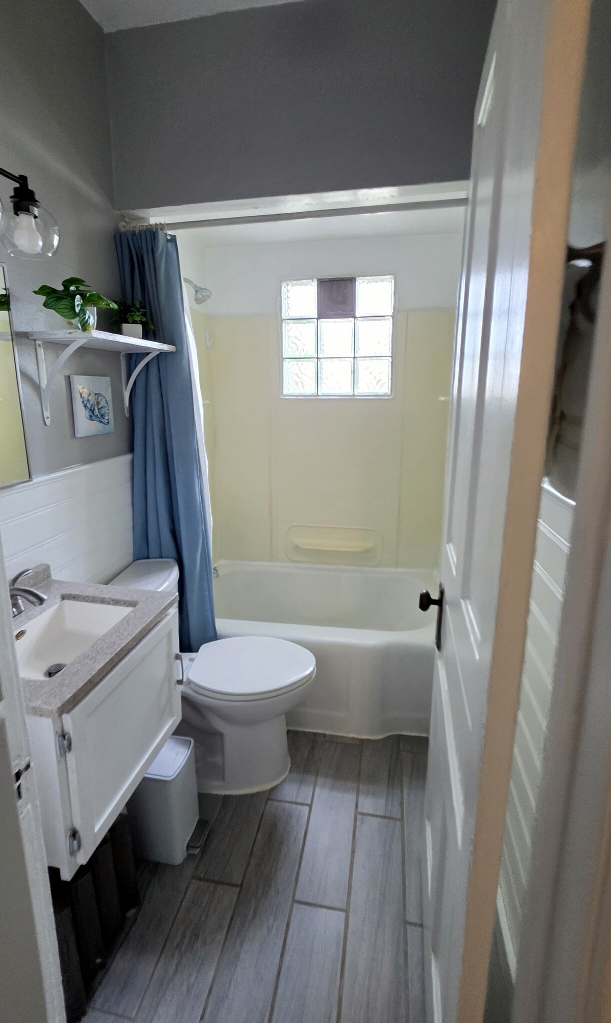 Updated bathroom with a full tub/shower combination and modern finishes. - 822 E 4th St