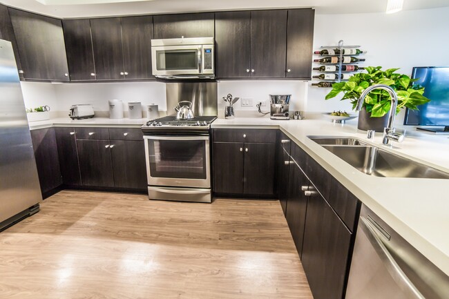 High-end stainless steel appliances and custom cabinets highlight our kitchens - The Arroyo Residences