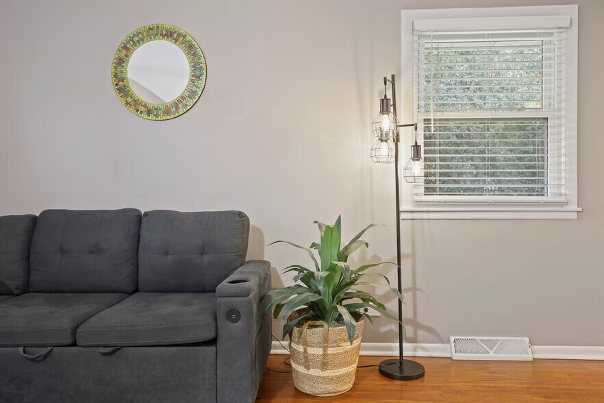 Bedroom 1 with king sized bed, sleeper couch, closet space and dedicated work table, chair and table - 1002 Juniper Ln